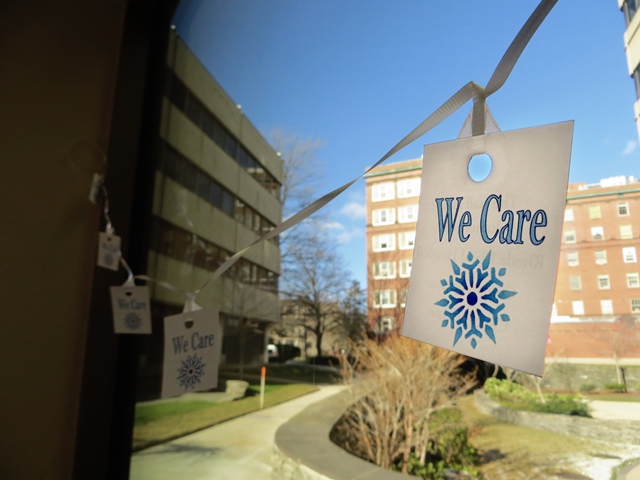 We Care sign hanging from a window