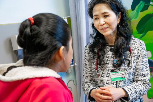 Dr. Tao Zheng meets with a pediatric patient
