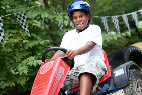 Child on a go-kart at Follow Your Heart Camp