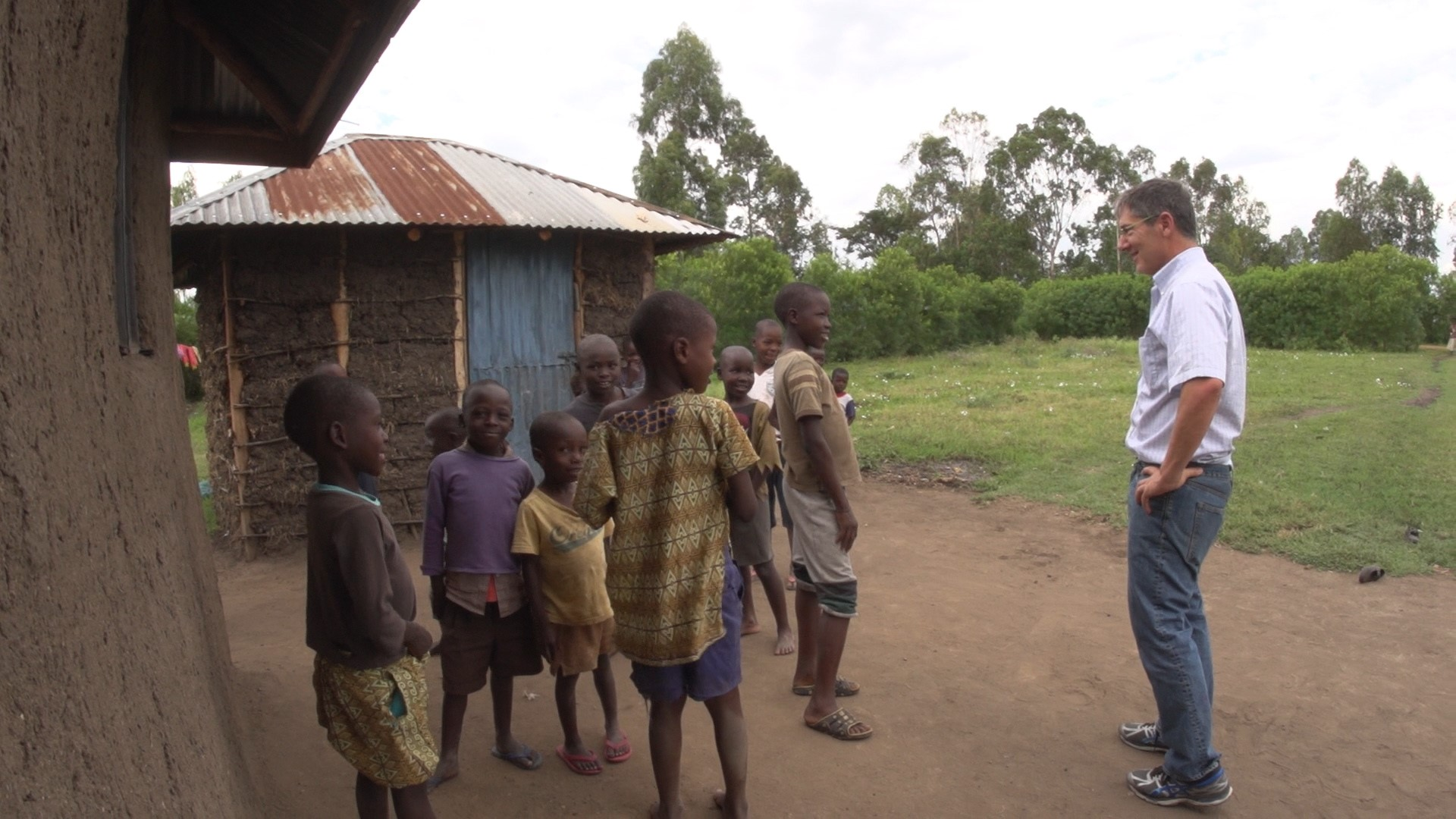 Dr. Jonathan Kurtis talks with a group of children in a rural village.