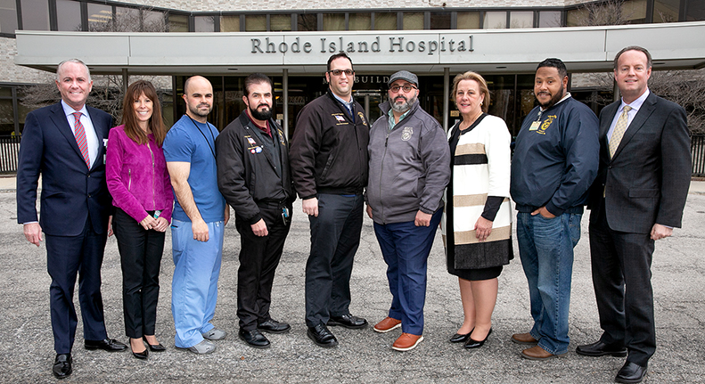 Members of Lifespan and Teamsters Local 251 leadership stand in front of Rhode Island Hospital