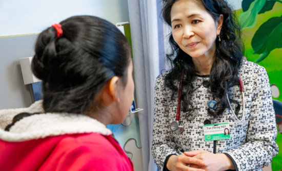 Dr. Tao Zheng meets with a pediatric patient