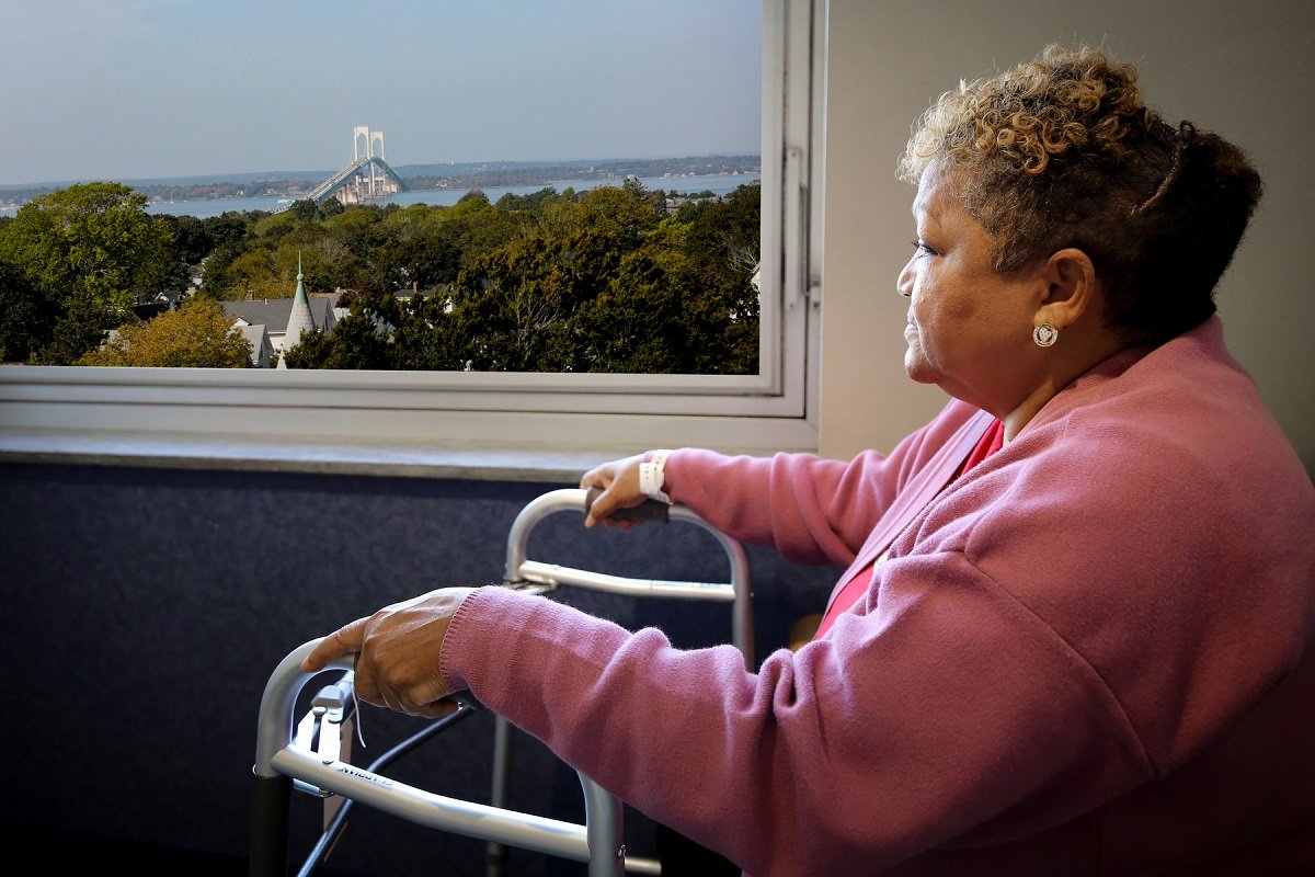 A woman sitting in a patient room at Vanderbilt Rehabilitation Center