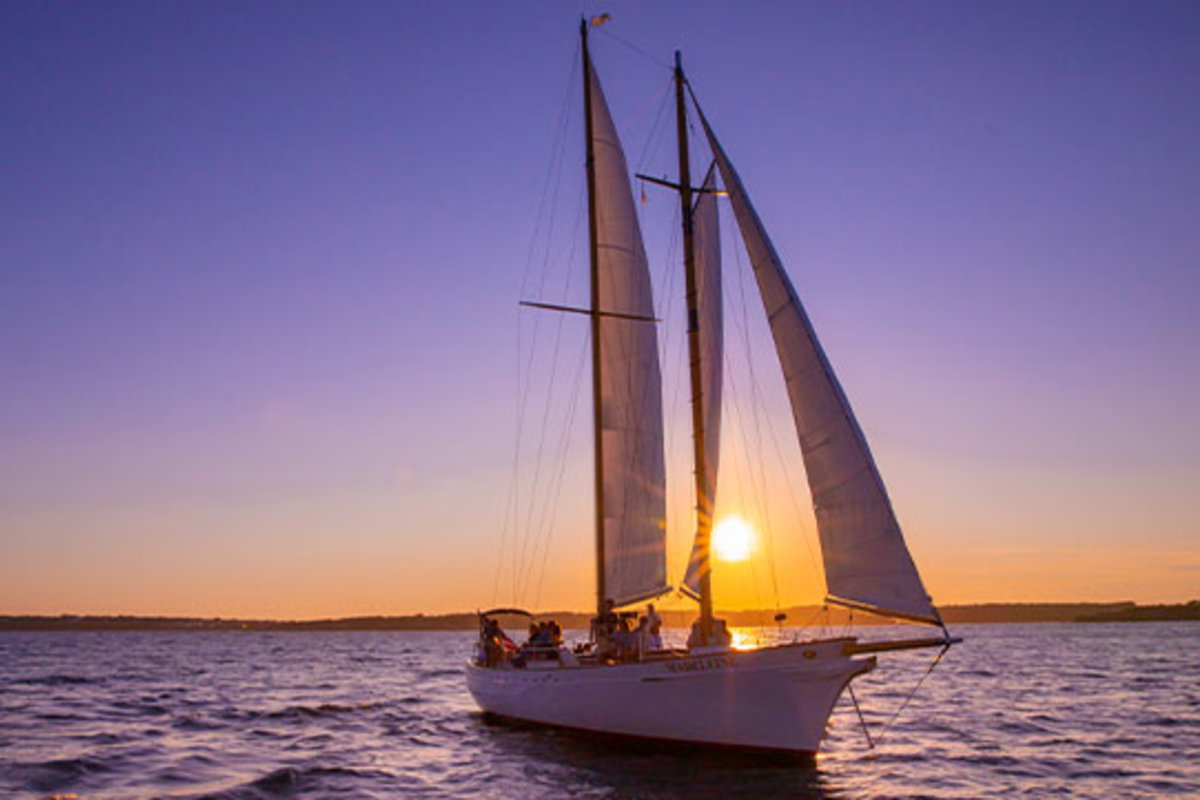 A sailboat at sunset.