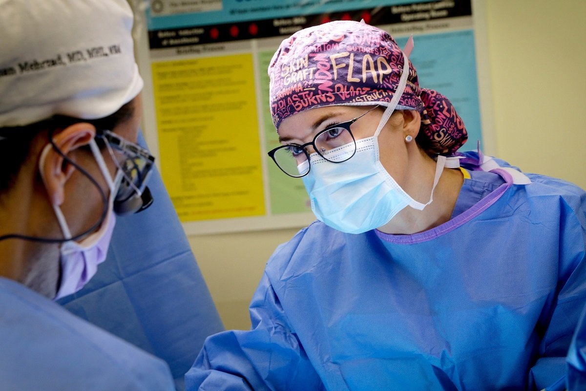 Lauren O. Roussel, MD in her scrubs in the operating room