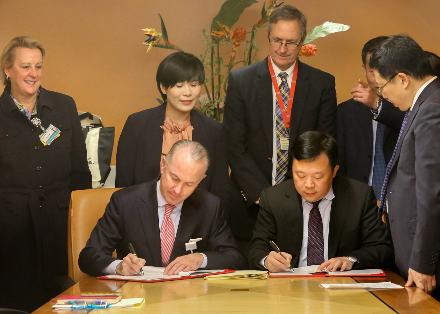 Leaders from Lifespan and Wuhan Union Hospital gather to sign an agreement